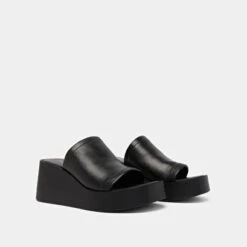 Mules Compensées En Cuir Noir 12 Mules Compensées En Cuir Noir -Xoxo Boutique 01W009471D.1708517221